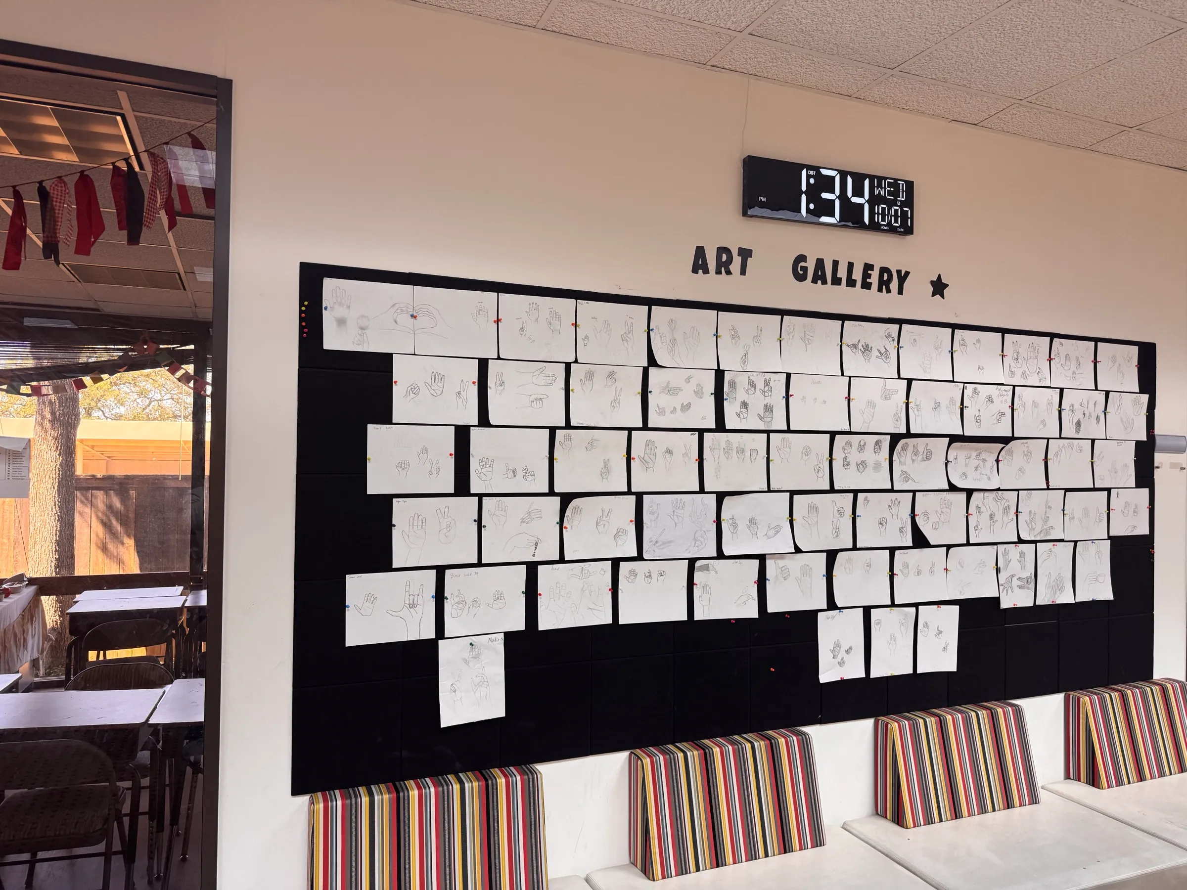 Art gallery wall displaying student artwork