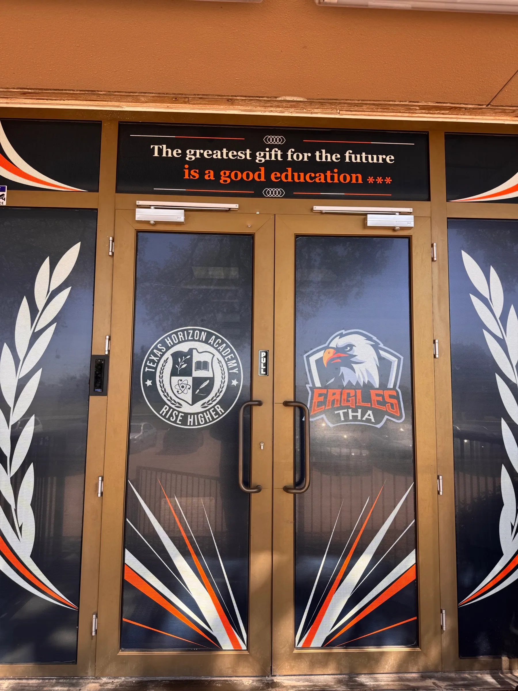 Front doors with the school seal and Eagles logo